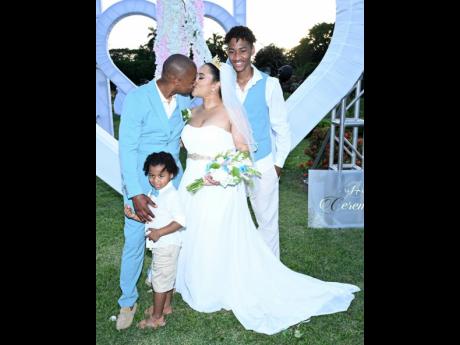 The bride and groom share a moment as they pose with sons Zenso (centre) and Zarel (right). 