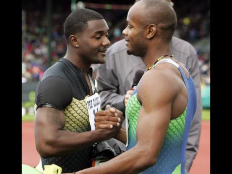 
Justin Gatlin, of the United States, and Asafa Powell, of Jamaica, congratulate each other after winning separate 100 metre races at the Prefontaine Classic in Eugene, Oregon in 2006.