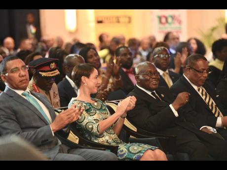From left: Prime Minister, Andrew Holness, Kamina Johnson Smith, and Anthony Hylton member of parliament representing the leader of the opposition, applaud Nana Akufo-Addo, president of the Republic of Ghana. at the opening ceremony for the 8th Biennial Ja