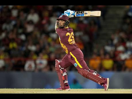 West Indies' Nicholas Pooran hits a six against Afghanistan during an ICC Men's T20 World Cup cricket match at Daren Sammy National Cricket Stadium in Gros Islet, Saint Lucia on  Monday, June 17, 2024. 