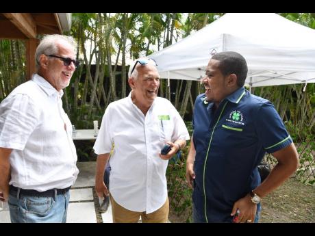 From left: Stephen Facey, chairman of Pan Jamaica Group; Charles Johnston, chairman of Jamaica Producers Group; and Minister of Agriculture, Fisheries and Mining Floyd Green share a light moment before embarking on the JP Farms school tour. 