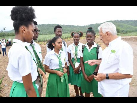 Charles Johnston (right), chairman, Jamaica Producers Group, gets the students of St Mary High School thinking about their future in agriculture. Since restarting the JP School Tours programme, six schools have been hosted, including St Mary High, White Ma