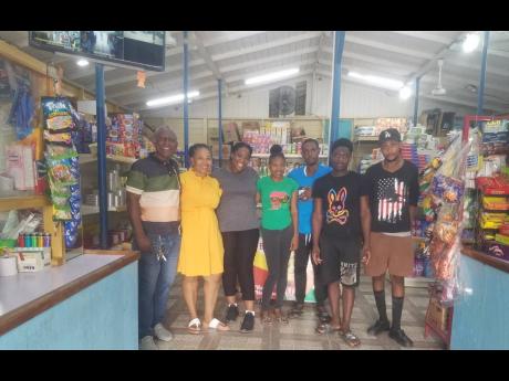 Donovan and Keleta Grant (left) along with some of the staff at Don & K Variety Store.