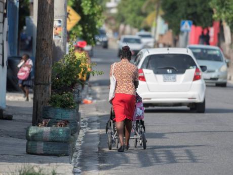 In this 2019 photo, a lady is seen pushing her child in a wheelchair on the road. Floyd Morris writes: ‘The rights and freedoms of persons with disabilities must therefore be recognised to allow for inclusion and non-discrimination in society on an equal