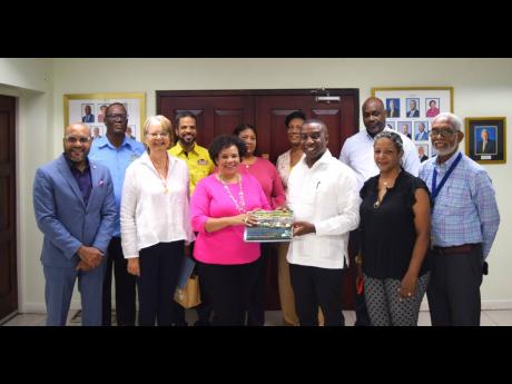 President of the Shipping Association of Jamaica (SAJ), Corah Ann Robertson-Sylester (third left), presents a copy of ‘History of the Shipping Association of Jamaica, 1939-2005’ to mayor of Kingston Andrew Swaby. They are joined by SAJ and KSAC represe