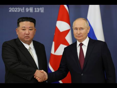 Russian President Vladimir Putin (right) and North Korea’s leader Kim Jong Un shake hands during their meeting at the Vostochny cosmodrome, outside the city of Tsiolkovsky in Russia, on September 13, 2023. 