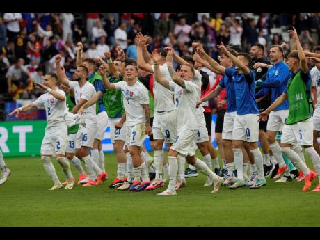 Slovakia players celebrate after a Group E Euro 2024 football match against Belgium in Frankfurt, Germany yesterday.