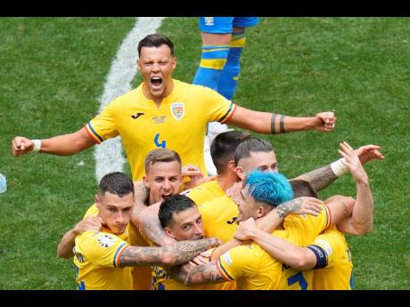 Romania players celebrate their win against Ukraine after the end of a Group E Euro 2024 match against Ukraine in Munich, Germany yesterday.