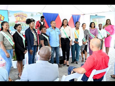 Floyd Green (centre), minister of agriculture, fisheries and mining, poses with the national parish queens at the launch of the Denbigh 70th Agricultural, Industrial and Food Show at Hi-Pro head office in White Marl, St Catherine, on Friday.