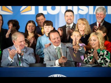 Louisiana Governor Jeff Landry signs bills related to his education plan on Wednesday at Our Lady of Fatima Catholic School in Lafayette, Louisiana.
