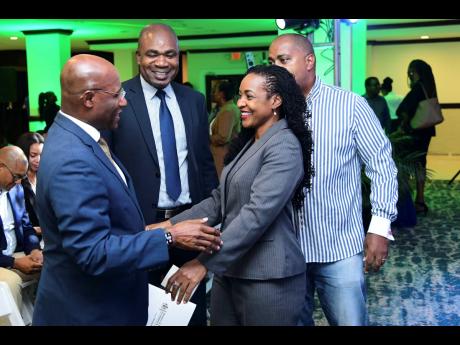 State Minister in the Ministry of Education and Youth Marsha Smith greets Minister of Industry, Investment and Commerce Senator Aubyn Hill (left) while State Minister in the Ministry of Finance and the Public Service Zavia Mayne (second left) and Shadow Mi