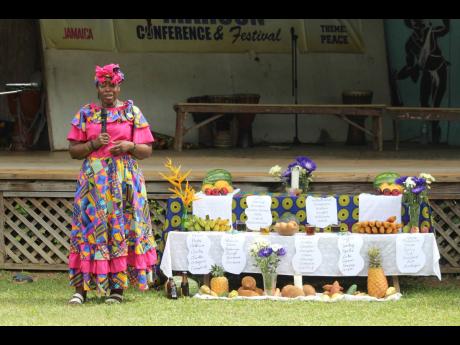 Charles Town Maroons Colonel Marcia Douglas addressing the gathering beside an ancestral altar during Quao Day celebrations on Sunday, June 23.