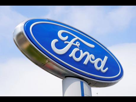 A Ford sign is shown at a dealership.