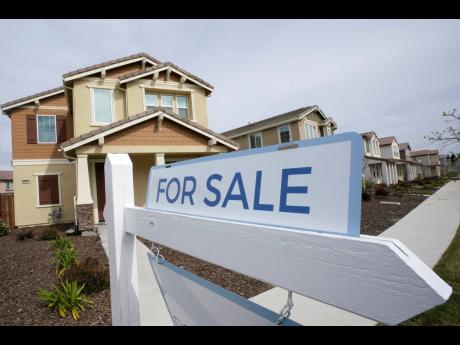 A ‘For Sale’ sign is posted in front of a home in Sacramento, California, on March 3, 2022.