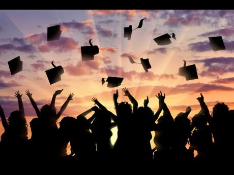 Representational image of graduates throwing their caps in the air.