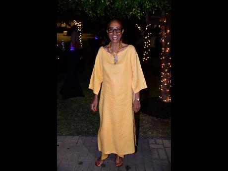 Beverley Manley-Duncan is a darling in yellow, smiling brightly at the camera.