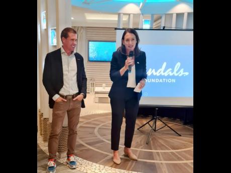 Heidi Clarke (right), executive director of the Sandals Foundation, speaking at the Sandals reception in London, as Chairman Adam Stewart looks on.