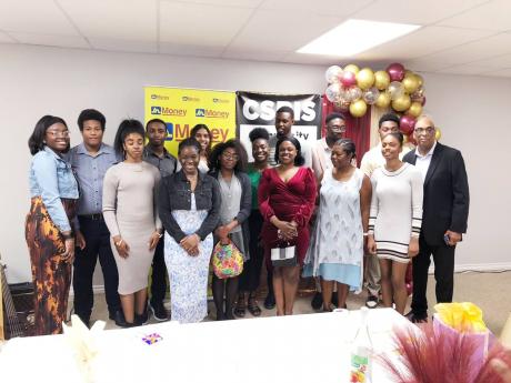  Paul Barnett (far right), and wife, Jacqueline (third from right), founders of the Community Support for Black International Students organisation, share the spotlight with the graduates.