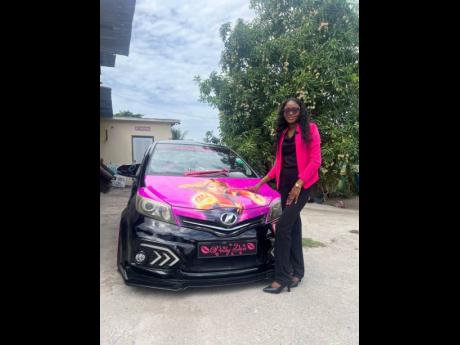 Business consultant and entrepreneur, Patecher Hinds poses with her upgraded 2012 Toyota Vitz. Some of the current upgrades to her car include changing the exterior colour from silver to black and upgrading all the lighting. 