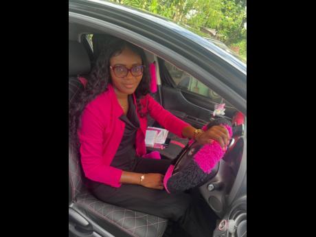 Patecher ‘Pinky’ Hinds, a car enthusiast, behind the wheel of her modified 2012 Toyota Vitz. 
