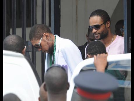 Entertainers Vybz Kartel and Shawn Storm leave the Home Circuit Court, where they were sentenced to life imprisonment on Thursday, April 3, 2014.