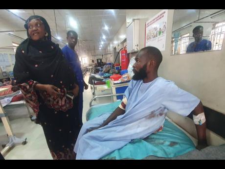 An injured victim of a suicide bomb attack receives treatment at a hospital in Maiduguri, Nigeria.