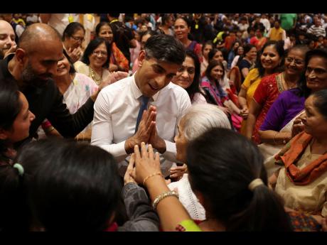 Prime Minister Rishi Sunak greets attendees during a visit to BAPS Shri Swaminarayan Mandir in northwest London, while on the general election campaign trail.