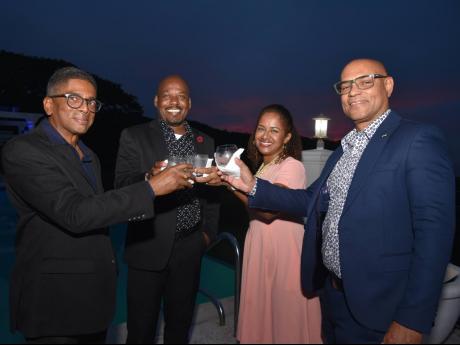 Richard Wallace (left), immediate past president of the Negril Chamber of Commerce and Industry, with Peter Higgins (second left), assistant vice-president, Treasury, at NCB; Sheree Martin, executive vice-president, Retail Banking & Customer Experience, NC