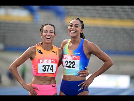 Aisha Praught-Leer (left) and Adelle Tracey show what great sportsmanship is all about after the women’s 1,500 metres at the JAAA/PUMA National Junior and Senior Championships.