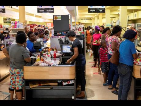 Customers purchase groceries ahead of Hurricane Beryl in Arnos Vale, 
St Vincent and the Grenadines, on Sunday, June 30.