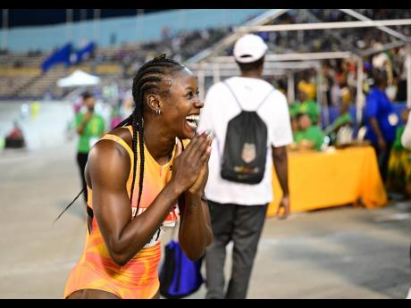 Shericka Jackson celebrates her win in the women’s 100 metres at the JAAA/PUMA National Junior and Senior Championships inside the National Stadium on Friday.