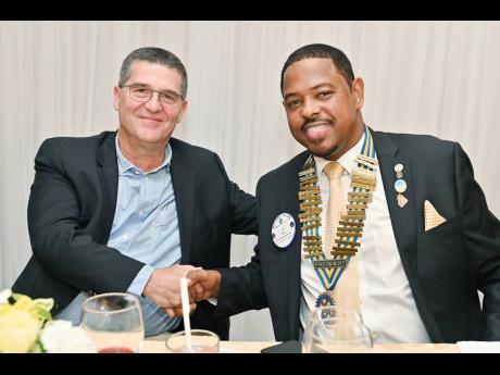 Newly installed president of the Rotary Club of St Andrew North, Ian Rose (right), welcomes William Mahfood, director of Food For The Poor Jamaica and chairman of the Wisynco Group, who was guest speaker at the recent 38th annual installation ceremony of t