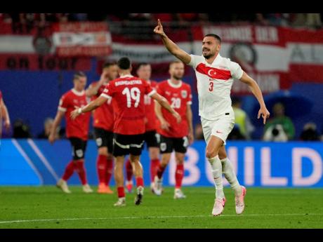Turkey’s Merih Demiral (right) celebrates his side’s second goal during a Euro 24 round-of-16 match against Austria in Leipzig, Germany yesterday.