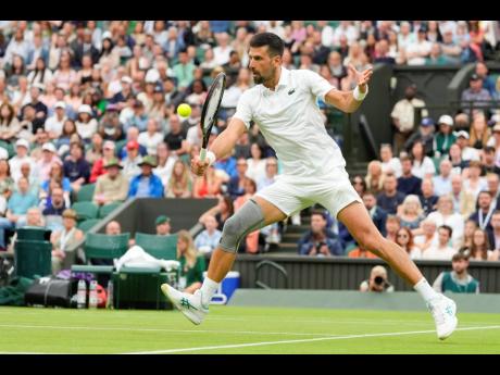 Serbia’s Novak Djokovic plays a backhand return to Vit Kopriva of the Czech Republic during their first-round match at the Wimbledon tennis championships in London yesterday.