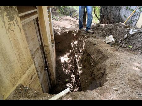 Several feet of silt was deposited into the couple’s yard after the landslide last November.
