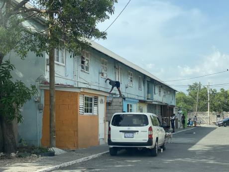 A man reinforces a roof in Port Royal, Kingston, on Tuesday in preparation for the passage of Hurricane Beryl.