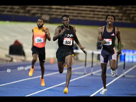 Malik James-King (Centre) powers to the finish line during the men’s 400-metre hurdles final at the National Stadium on Friday. Roshawn Clarke (right) and Jaheel Hyde were the second and third-place finishers respectively.