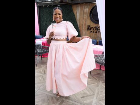 Matching the exact hue of her drink, Tyheissa Williams, brand and corporate public relations manager at Red Stripe, is fun and flirty in this two-piece from Dashing boutique. 
