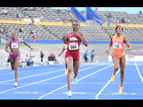 Nickisha Pryce (centre) runs to a second national title during the JAAA/PUMA National Junior and Senior Championships inside the National Stadium on the weekend. Stacey-Ann Williams (right) was second.