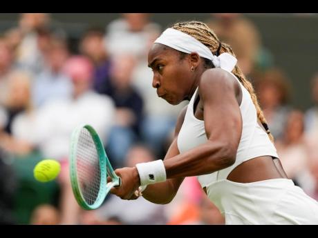 Coco Gauff of the United States plays a backhand return to Anca Todoni of Romania during their match on day three at the Wimbledon tennis championships in London yesterday.