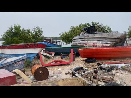 Boats sitting idle on the shore as fisherfolk watched over them at the Forum Fishing Village in Portmore, St Catherine, as Hurricane Beryl passed the island.