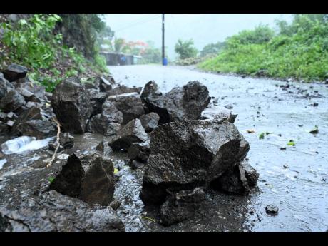Fallen rocks partially block a section of Gordon Town Road in St Andrew on Wednesday after a landside triggered by persistent heavy rainfall caused by Hurricane Beryl.