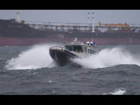 A Jamaica Defence Force (JDF) coastguard boat hitting huge waves in the Kingston Harbour. The JDF announced that it has launched a search and rescue mission to find 11 fishermen who have been reported missing since Tuesday. The Maritime Air and Cyber Comma