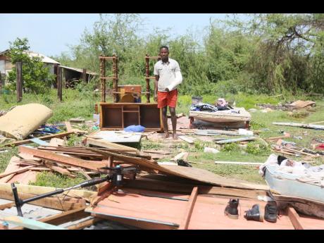 Carlton Golding of Mitchell Town, Clarendon, stands amid his possession after his home was ripped apart by Hurricane Beryl last Wednesday.