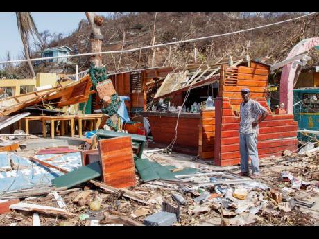 A man stands next to a business destroyed by Hurricane Beryl in Clifton, Union Island, St Vincent and the Grenadines on July 4.