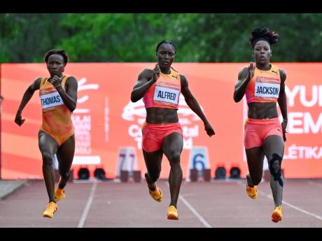 Lanae-Tava Thomas (left) of Jamaica, Julien Alfred (centre) of St Lucia, and Shericka Jackson of Jamaica, compete in the 200 metres at the Gyulai Istvan Memorial Track and Field Hungarian Grand Prix in Szekesfehervar, Hungary yesterday