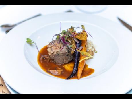 The main entrée - Red Stripe cured lamb rack, smoked Italian sausage and spinach stuffing; Shiitake mushroom reduction; breadfruit, plantain and coconut prepared by Tyrone Jackson, executive chef, Couples Sans Souci.