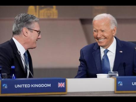 President Joe Biden (right), talks with British Prime Minister Keir Starmer before the opening session of the NATO Summit yesterday.