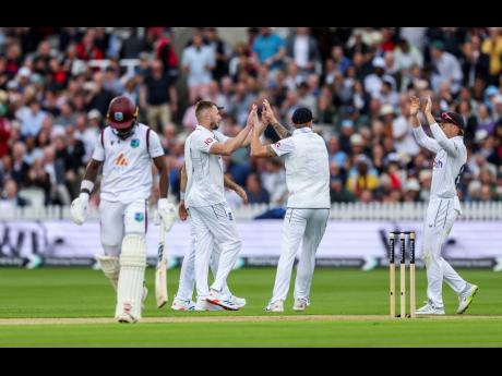 England’s Gus Atkinson (second left) and Zak Crawley celebrate with teammates following the wicket of West Indies’ Kirk McKenzie (not in picture) on day one of the first Rothesay Men’s Test match at Lord’s Cricket Ground, London yesterday.