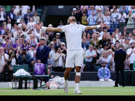 Lorenzo Musetti of Italy celebrates after defeating Taylor Fritz of the United States in their Wimbledon quarter-final tennis match in London yesterday.